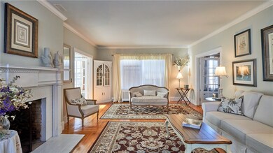 Living room boasts fireplace and built-in corner c