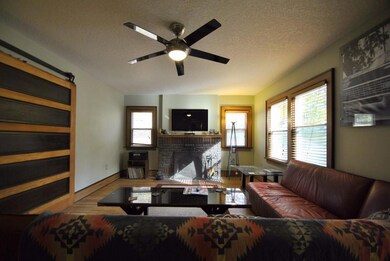Spacious living room features original hardwood fl