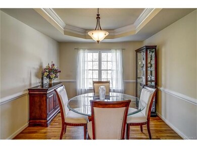 Trey ceiling, chair rail, double windows in dining room.