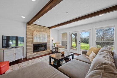 Living room with wood finished floors, a premium 