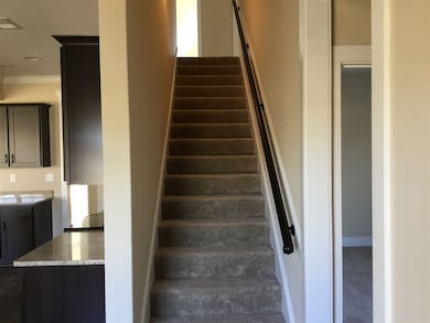 Stairs off kitchen next to second bedroom down Ups