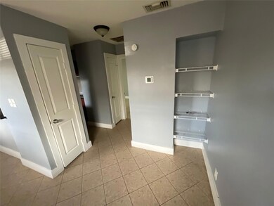 Unfurnished bedroom featuring light tile patterne