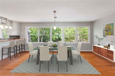 Dining area has natural wood floors and and wide b
