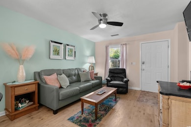 Living room featuring light wood-type flooring, a 