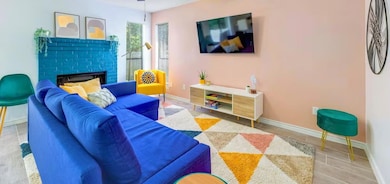Living room featuring a fireplace and baseboards