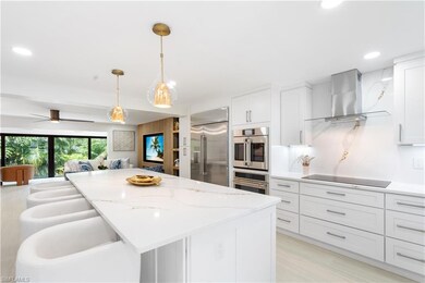 Kitchen with a kitchen island, pendant lighting, w