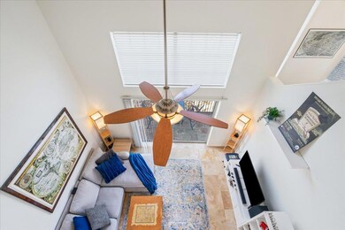 Living room with a high ceiling and a ceiling fan