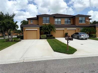 View of front facade featuring driveway and stucco