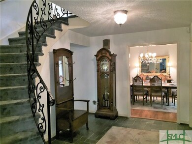 Pretty entrance foyer with curved staircase and th