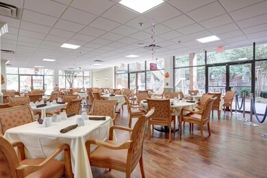 Dining area featuring wood finished floors and a drop ceiling