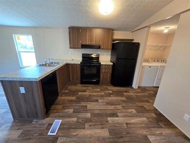 Kitchen featuring visible vents, black appliances