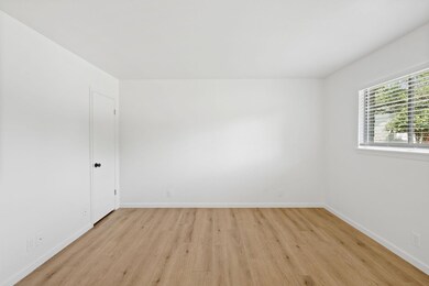 Empty room with light wood-style flooring and bas