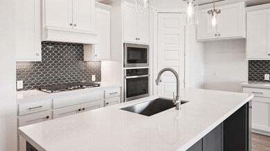Kitchen featuring appliances with stainless steel