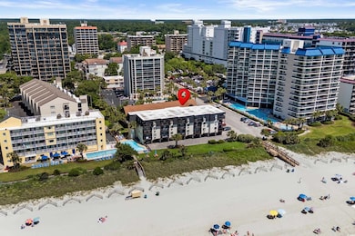 Aerial view of apartment complex / building and a pool
