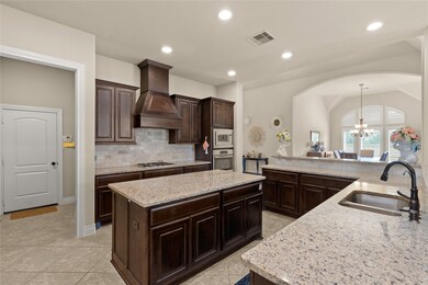 This kitchen is by far any chef’s dream! This spacious kitchen features high ceilings, dark stained wood cabinets, granite countertops, SS appliances, modern tile backsplash, recessed lighting, extended counter space, granite kitchen island with double sink and space for breakfast bar, and a walk-in pantry all overlooking your huge family room.