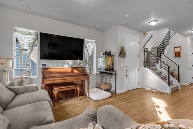 Living area - stairway, wood finished floors, and plenty of natural light