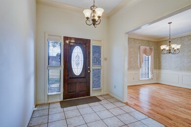 Beautifully tiled front door entryway with the formal dining area just to the side.