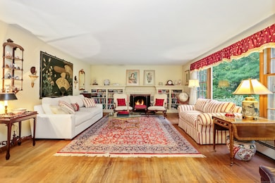 Living room with fireplace and built-in bookcases.
