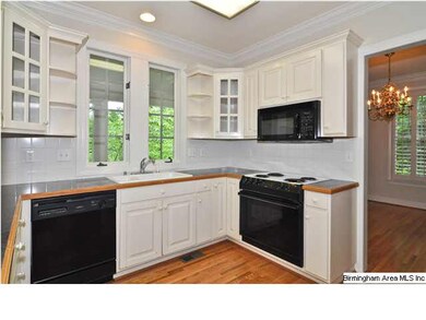 An efficient kitchen with white cabinets, double s