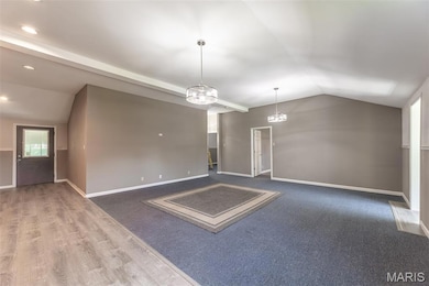 Unfurnished room with vaulted ceiling and recessed lighting