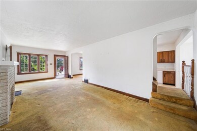 Carpeted living room featuring a textured ceiling 