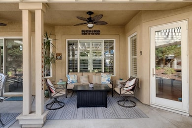 Patio sitting area  featuring ceiling fan, a patio area, and outdoor lounge area