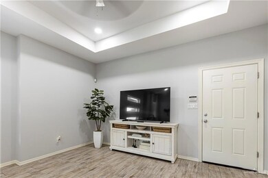 Living room featuring light wood-style floors, baseboards, a ceiling fan, and recessed lighting