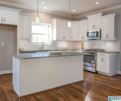 Features Custom Shaker Cabinetry, Oversized Island