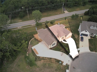Aerial view showing the home and its lot.
