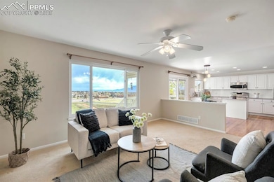Living area featuring light colored carpet, visibl