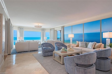 Living room with ornamental molding and a water view
