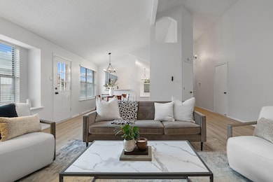 Living area featuring lofted ceiling, a notable ch