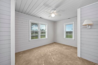 Empty room featuring carpet, a healthy amount of s