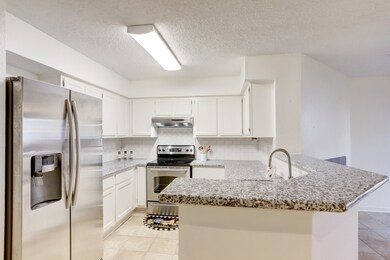 The kitchen has been remodeled with attractive gra