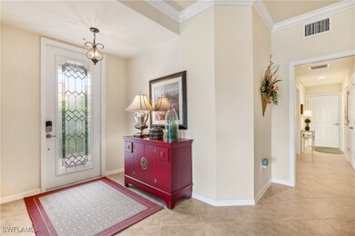 Tiled foyer with ornamental molding