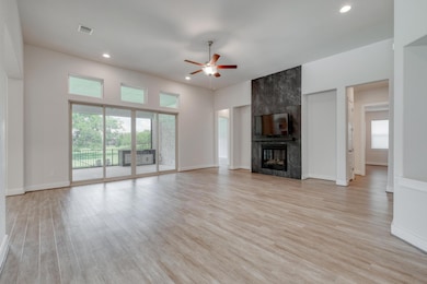 Unfurnished living room with a ceiling fan, reces
