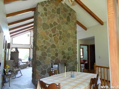 Other. Stone fireplace soars to the cathedral ceil