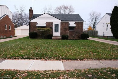 Bungalow-style home featuring a front yard and a garage