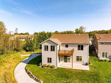 Rear view of property with a yard, a wooden deck, 