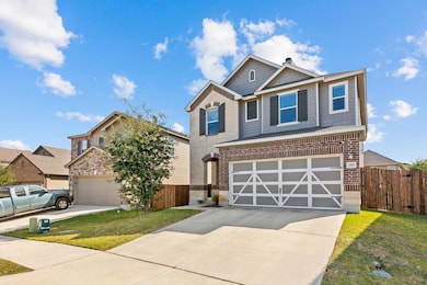 View of front of property with driveway and brick siding