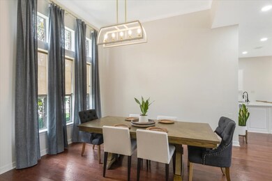 The spacious dining room offers custom blinds and