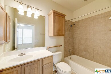 This attached master bath features tile flooring,