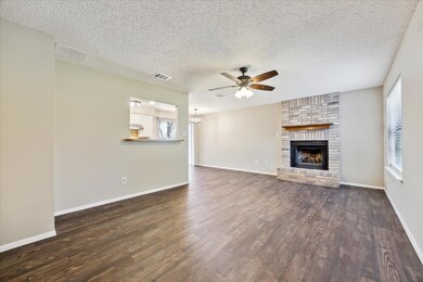 Unfurnished living room with ceiling fan, a textu