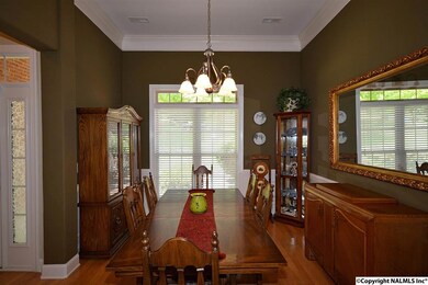 Features 10' ceilings w/crown molding, hardwood floors, wainscotting, and plantation blinds.