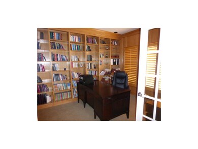Private 1st floor library w/ plantation shutters.