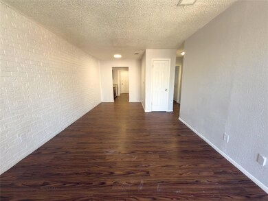 Hall with dark wood-style flooring, baseboards, b