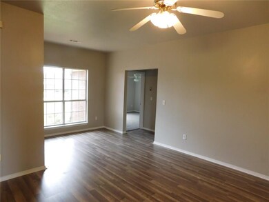 View back toward the front windows in living room. The entire house has new flooring and paint!