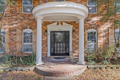 Entrance to property featuring brick siding