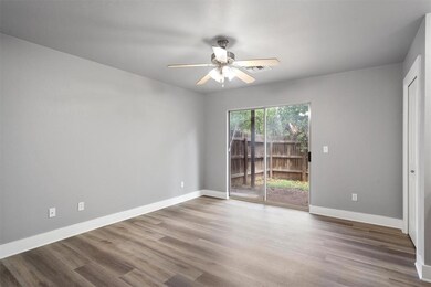 Empty room featuring a ceiling fan and wood finis
