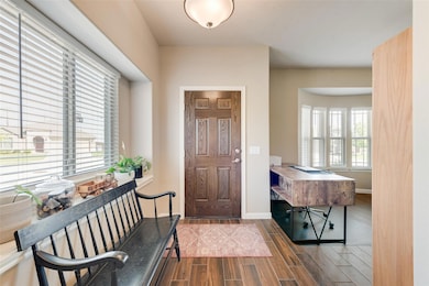 Foyer with wood style floors and decorative lighti